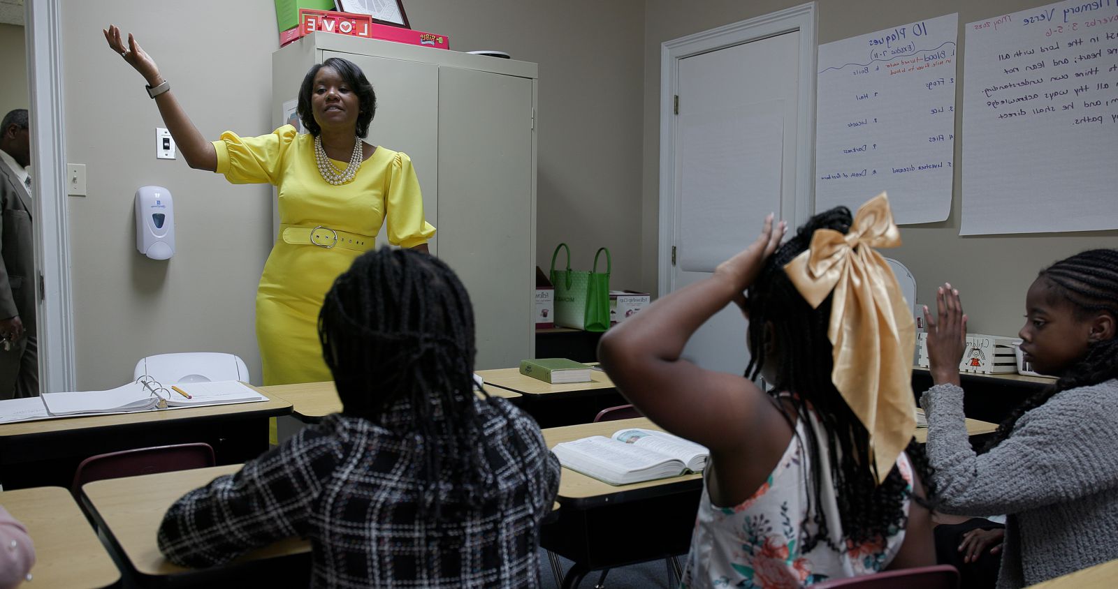 Woman standing and teaching a children's Sunday school